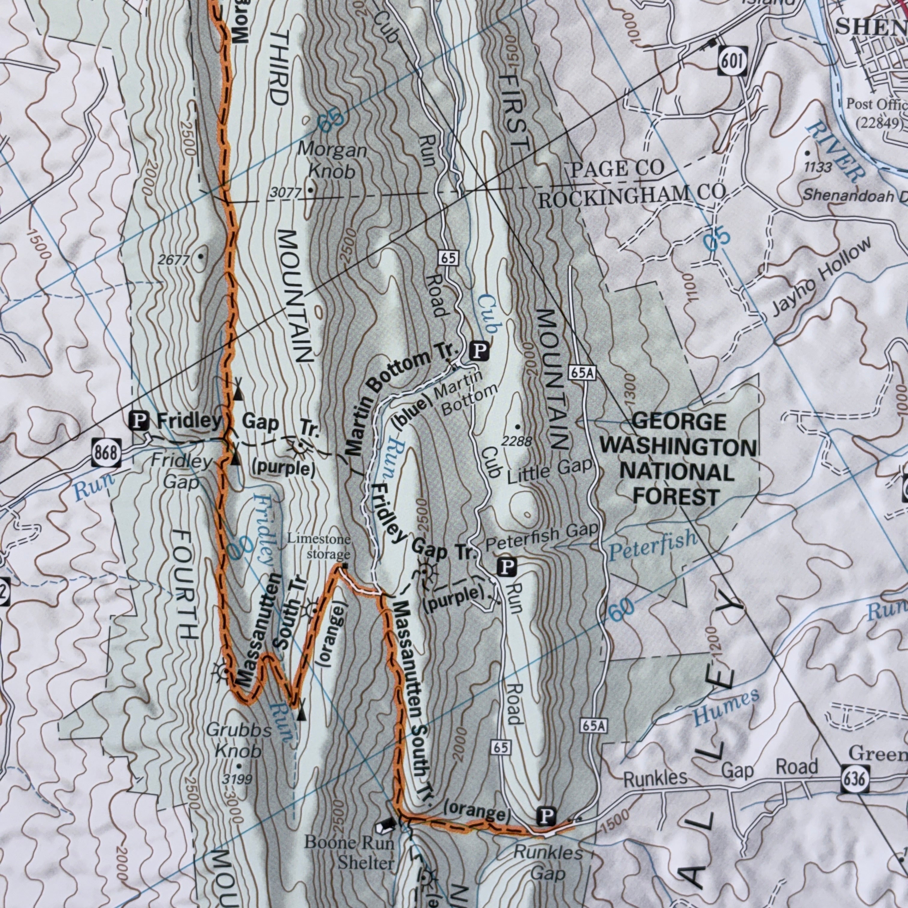 Topographic map of a mountainous area with trail names and forest designations.
